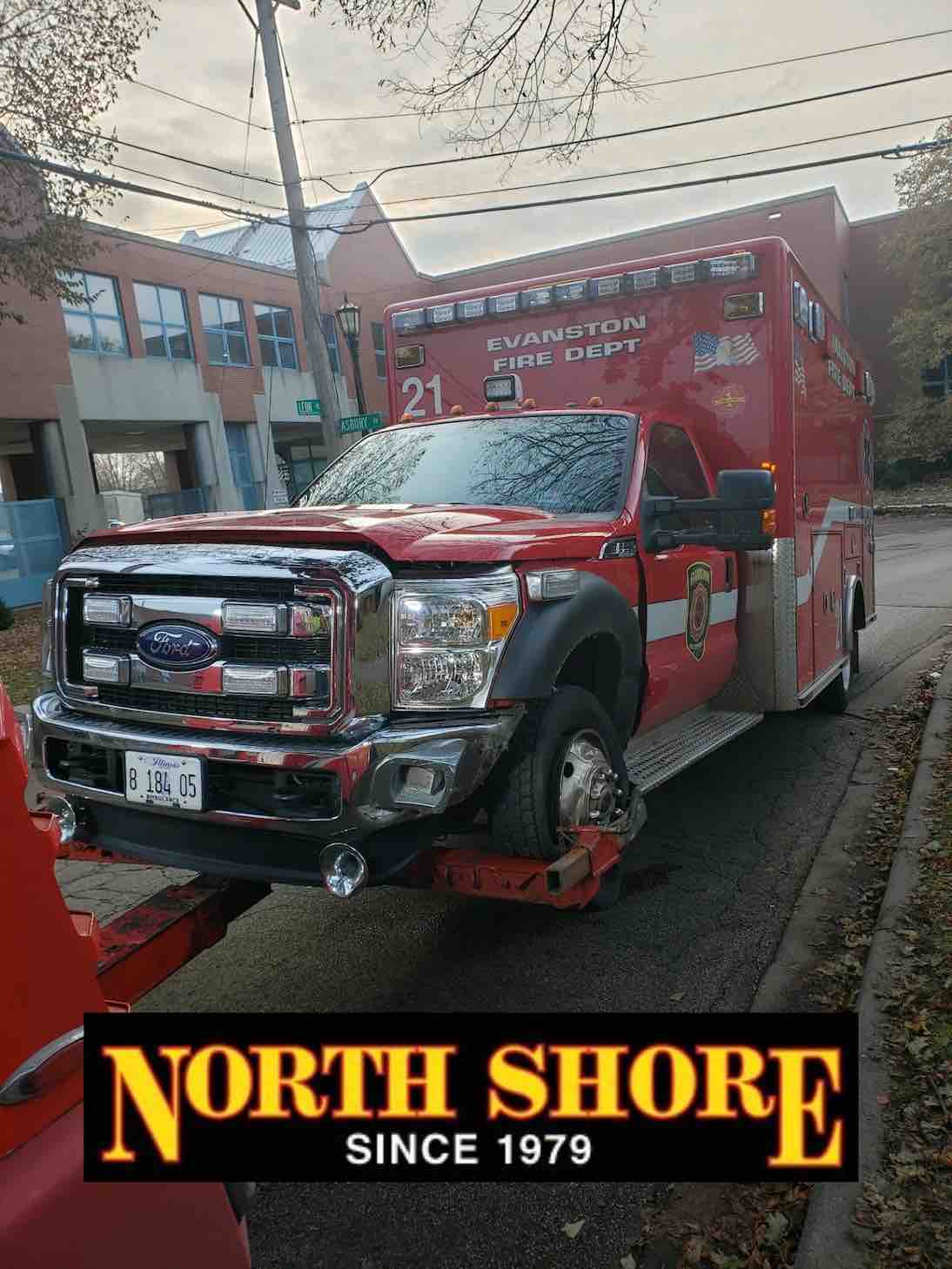 Ambulance on back of heavy wrecker during heavy duty towing