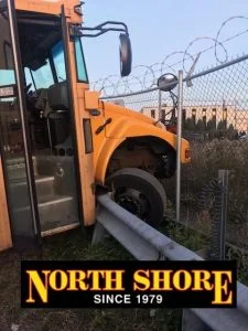 Yellow Bus over Rail before Bus Towing Company Arrives